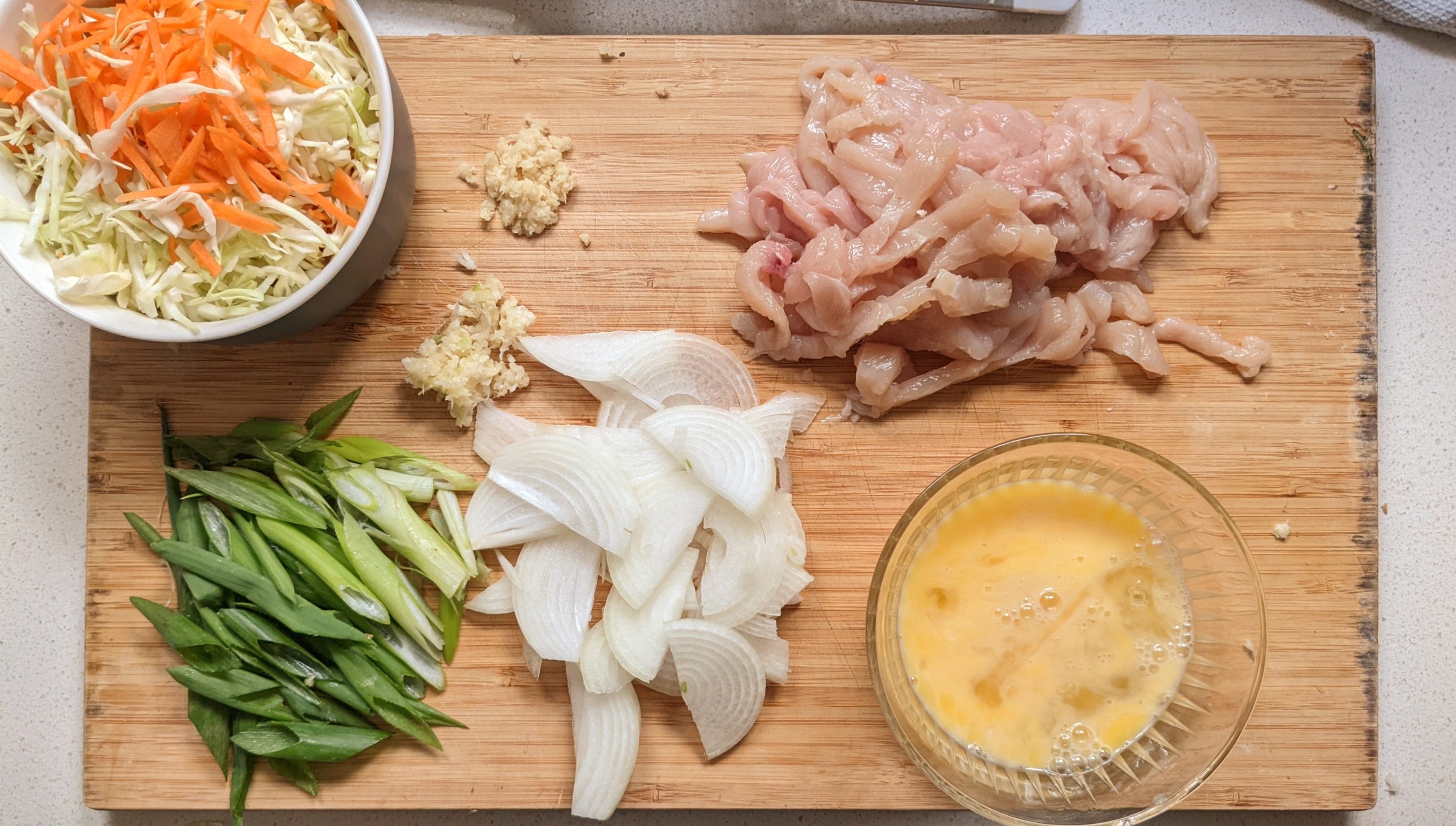 Fried rice ingredients prepped on a cutting board