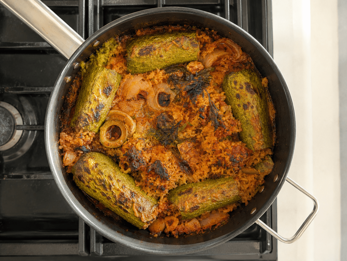 Finished stuffed zucchini in the pot with browned tops over tomato rice after the grill